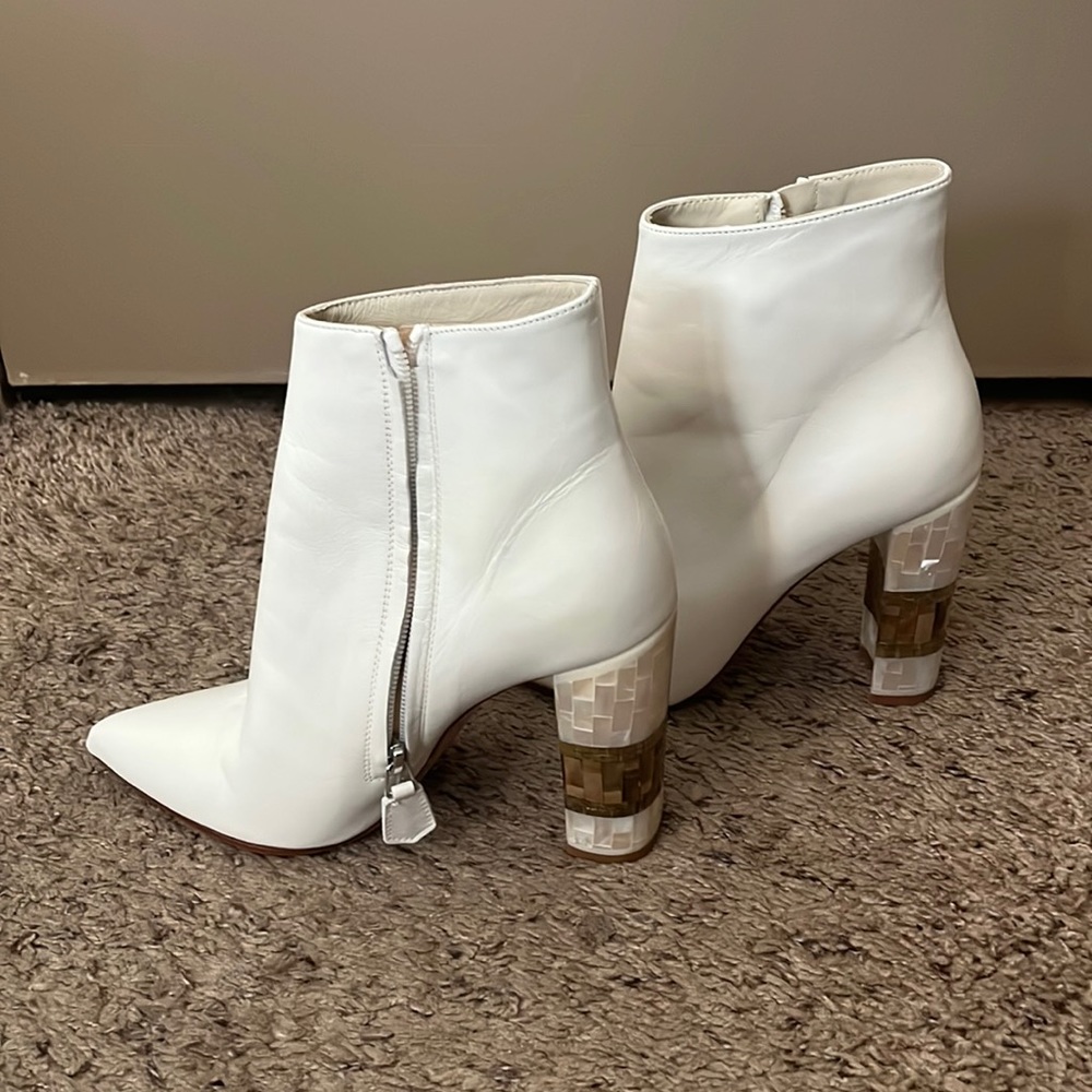 Never worn. White leather with mother of pearl and brass block heal